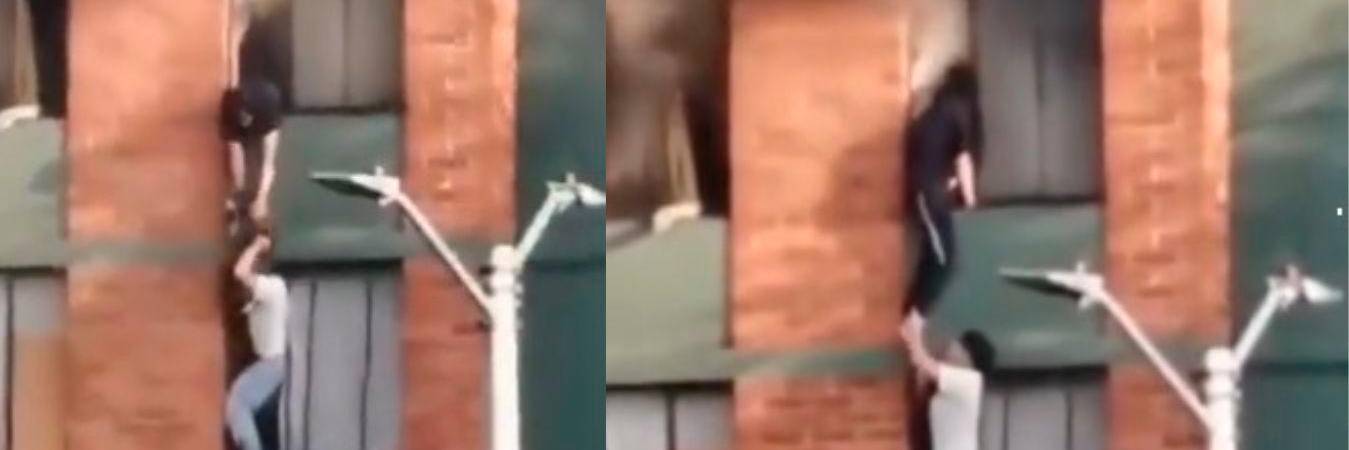 El joven se paró en el marco de la ventana y rescató a la joven y a su perrito. /FOTOS: CAPTURAS DE VIDEO 